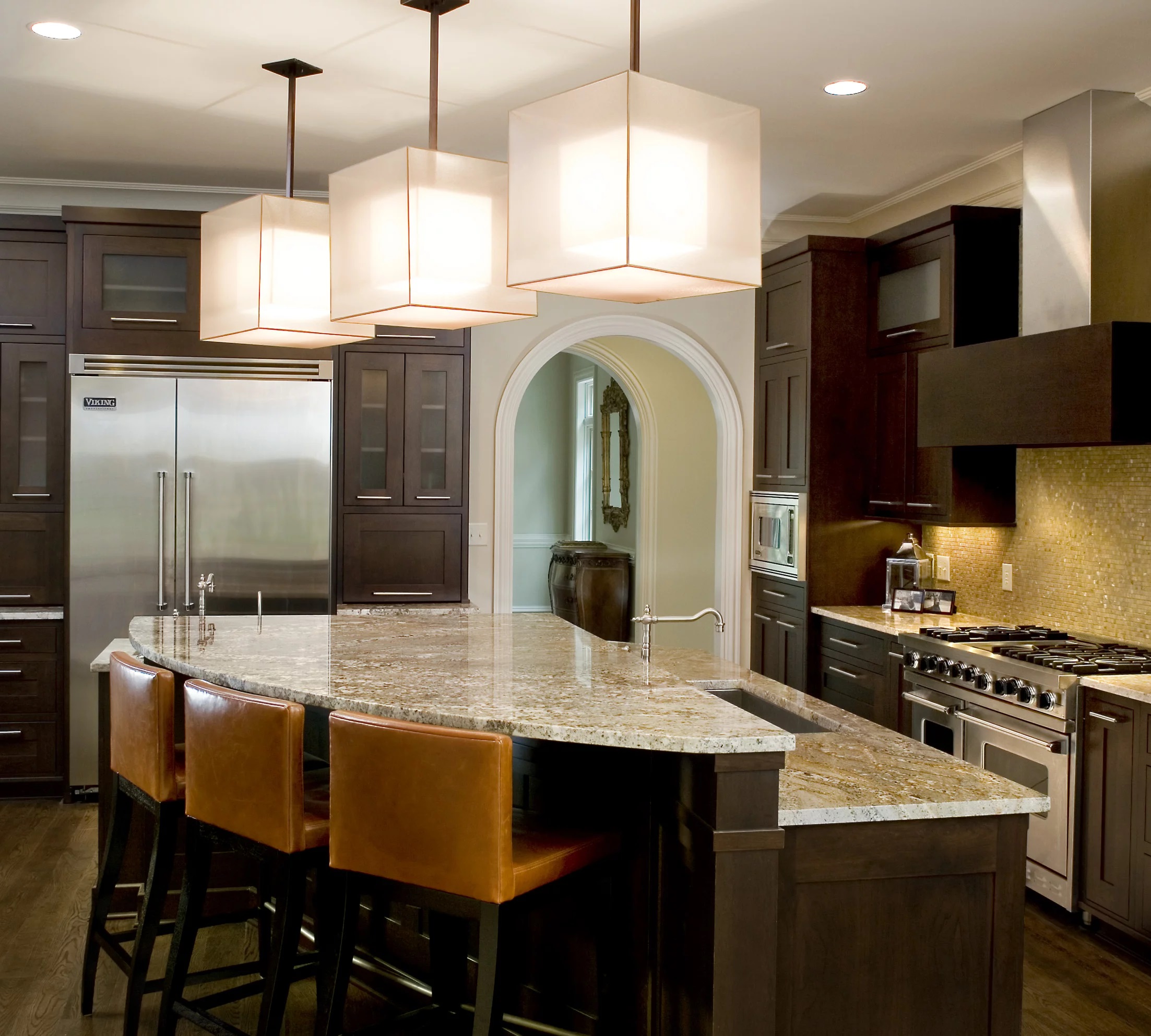 Open kitchen layout with updated cabinetry, counters, and lighting